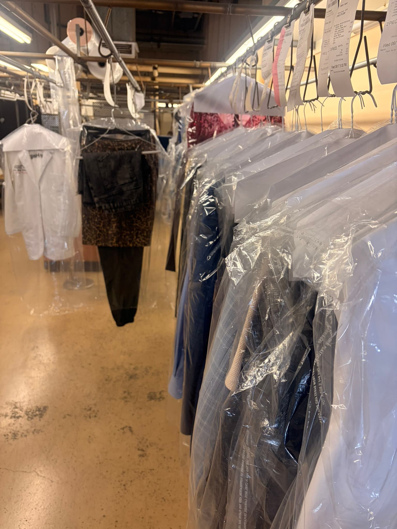 Finished garments on rack at Eco Cleaners